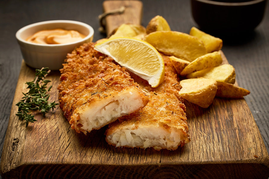 Fried Fish with lemon and sauce on a serving board